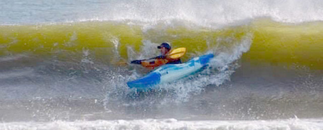tom p ocean surfing in whitewater kayak about to get munched